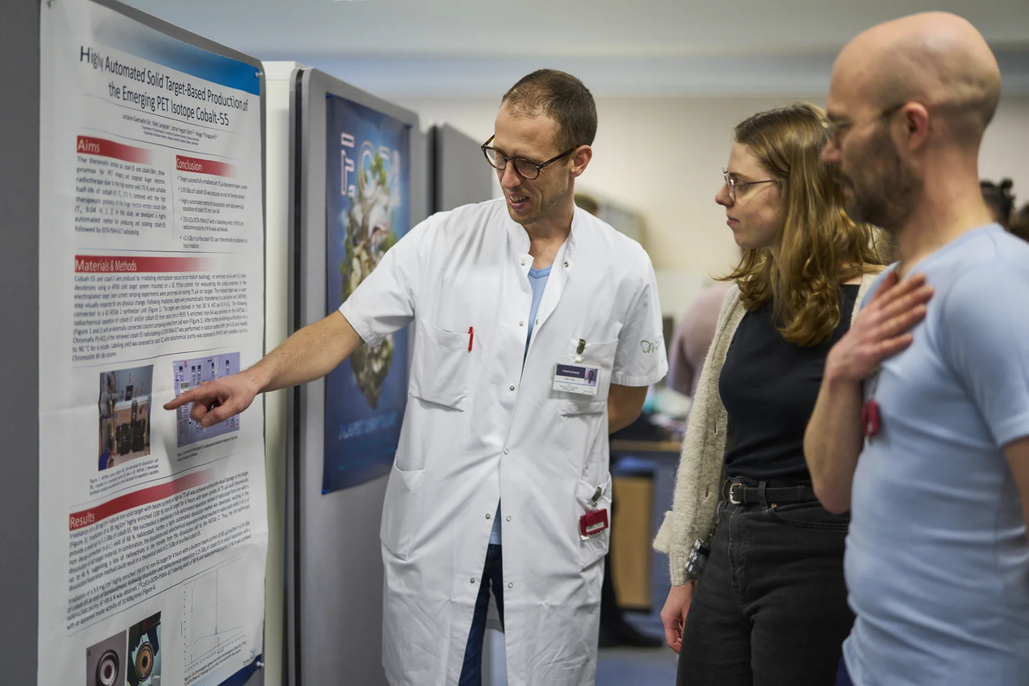 Photo of people looking at a research poster