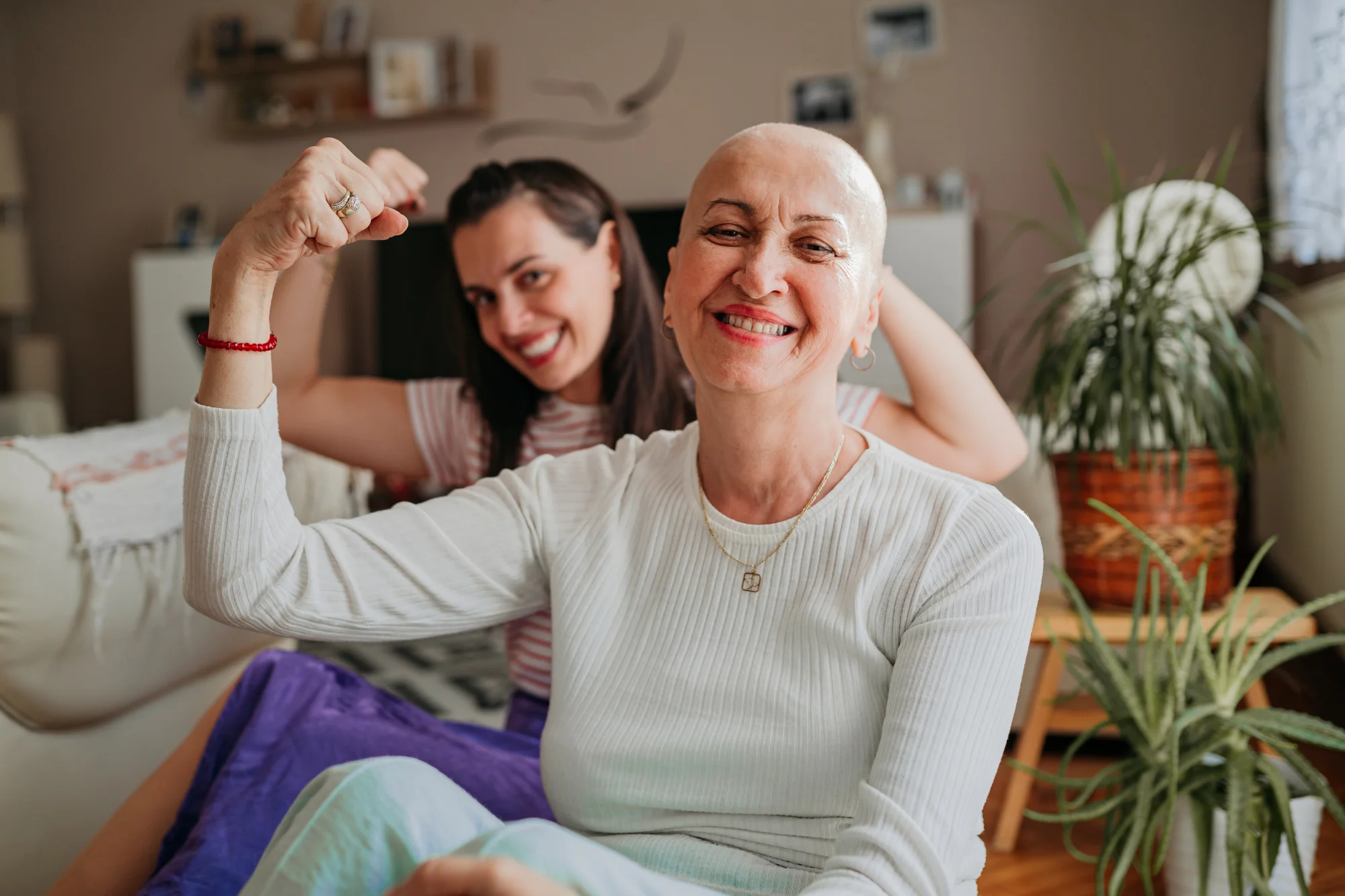 Photo of two women flexing their muscles