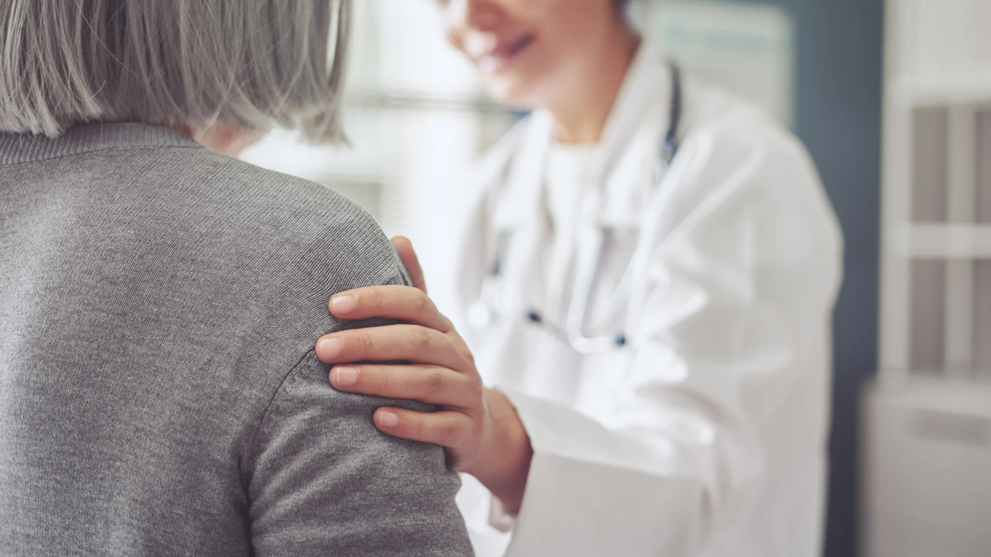 Photo of a doctor comforting a patient